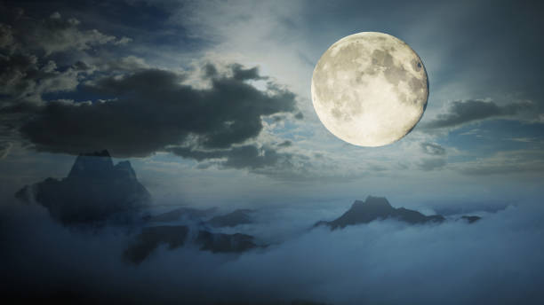 istock Dramatic sky with tree, full moon and clouds over mountain, Cool blue tone. 806691388