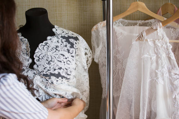 istock Dress designer making lace wedding dresses.Handmade. 806692000