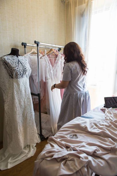 istock Dress designer making lace wedding dresses.Handmade. 806692536