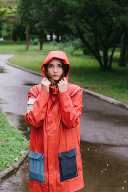 istock Woman in raincoat under the rain 806697984