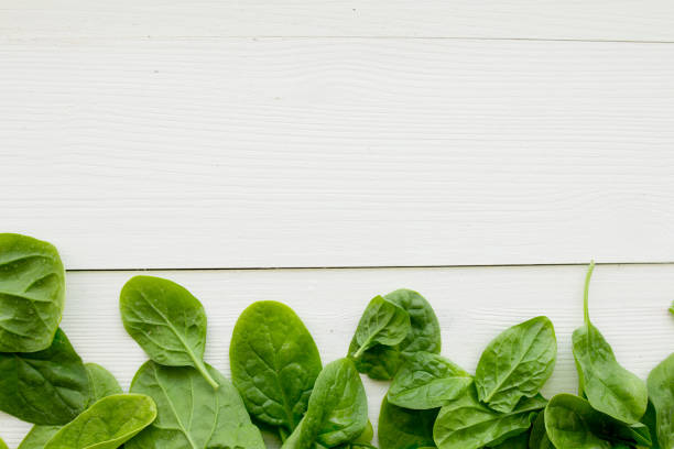 istock Spinach leaves on white wooden 806698734