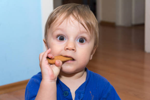 istock Cute baby is eating snack 806700236