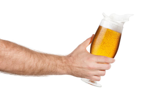 istock hand with glass of splashing beer 806701052