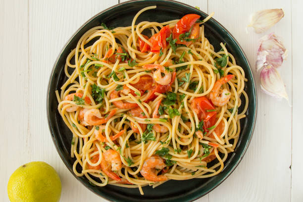 istock Spaghetti with shrimps and tomatoes top view 806701086