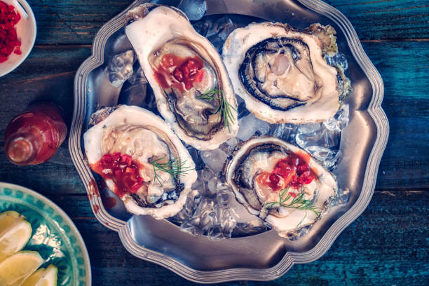 istock Oysters on plate with Tabasco sauce and lemon 806706856