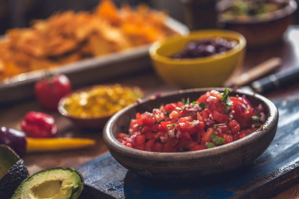 istock Preparing Mexican Tacos with Spicy Salsa, Minced Meat and Guacamole 806710694