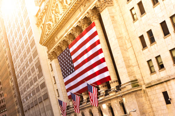 Famous Wall street and the building in New York, New York Stock Exchange with patriot flag