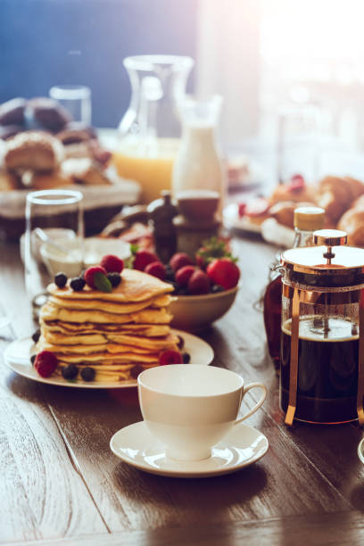 istock Stack of Pancakes with Maple Syrup, Berries and Fresh Coffee 806713612