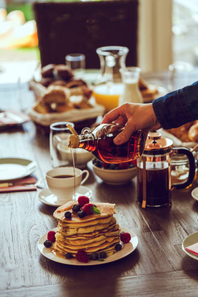 Stack of Pancakes with Maple Syrup, Berries and Fresh Coffee
