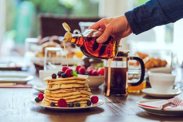 Stack of Pancakes with Maple Syrup, Berries and Fresh Coffee stock photo