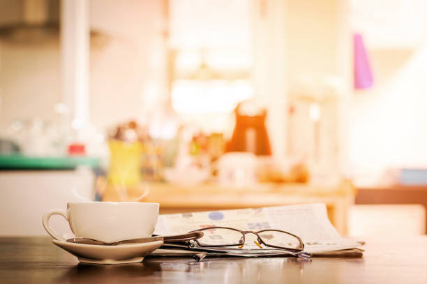 istock cup of hot cappuccino coffee with newspaper and spectacles 806717366