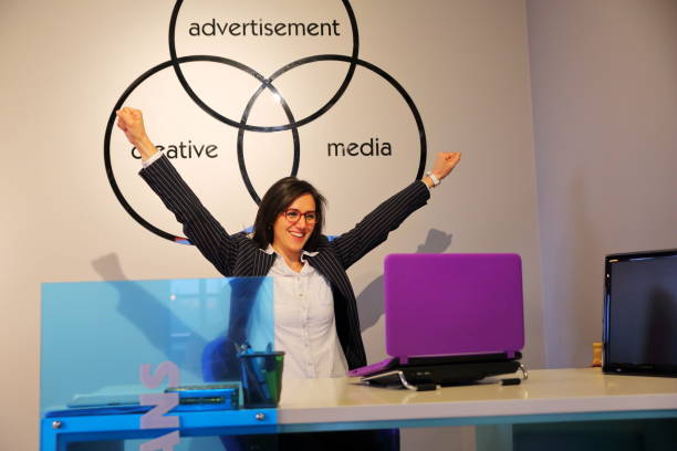 istock Businesswoman with laptop cheering 806717552