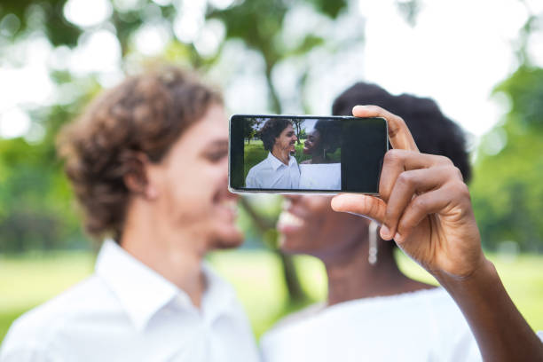 istock Cheerful young mix-raced couple taking selfie 806730032