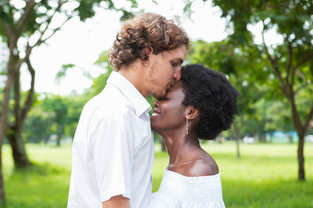 istock Loving young man kissing girlfriend on forehead 806730090