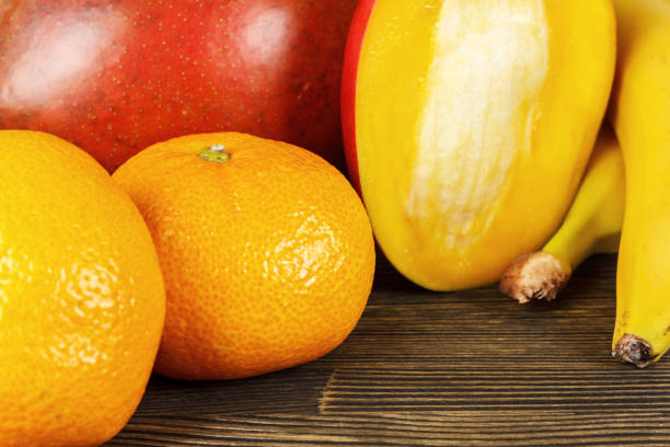 Close-up of tropical fruits on wooden table