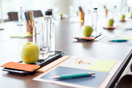 Closeup of conference table with water and stationery sets