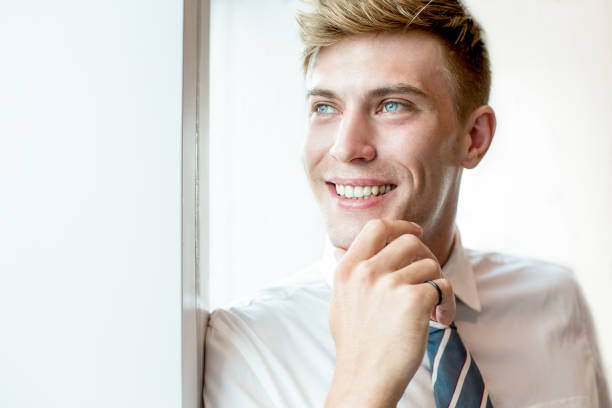 istock Dreamy Adult Business Man Looking Through Window 806733882