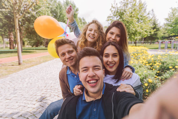 istock Best friends having fun and taking selfie at park 806734260