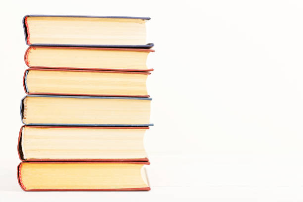 istock A stack of old books on a light beige background 806743216