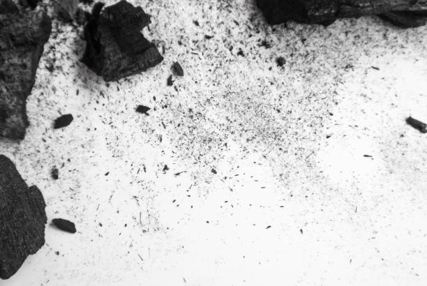 istock Black abstract textured composition on a white background, a selected focus close-up of a pile of cubes and powder of black mineral coal. 806744346