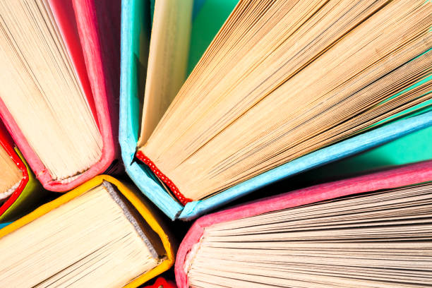 Top view of bright colorful hardback books in a circle.