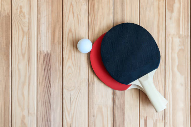 Two ping pong paddles with ball stock photo