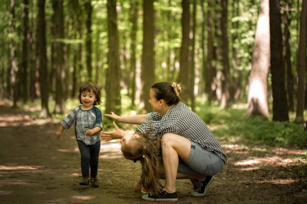 istock Mother with young daughters walk in the woods 806757884