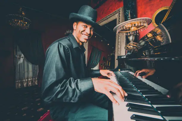 Photo of Musician playing the piano in nightclub bar