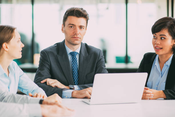 istock Serious businessman at meeting with colleagues 806760290