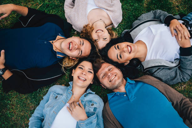 istock Happiness young friends lying down in the grass outside 806760972
