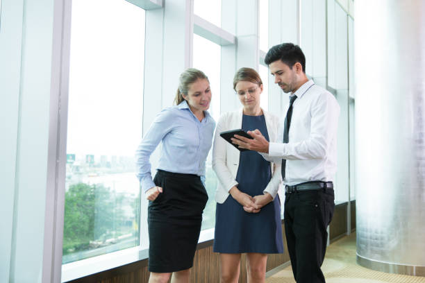 istock Smiling business team looking at digital tablet 806766066