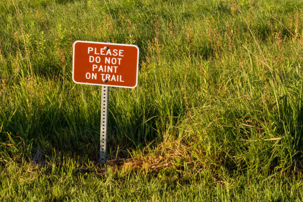 istock sign asking people to stop painting on a public trail 806773880
