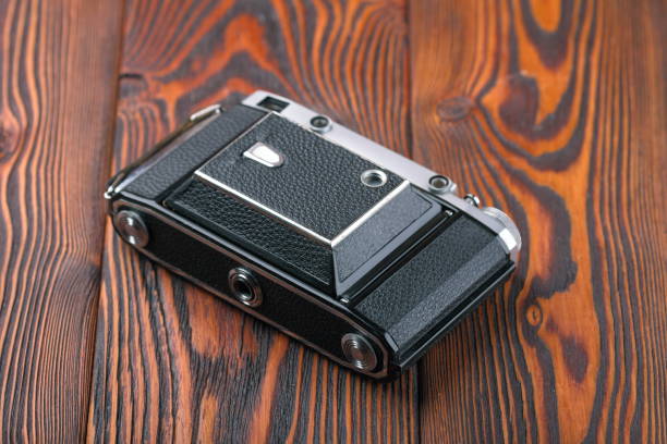 istock The old rangefinder camera on a wooden background. 806785186