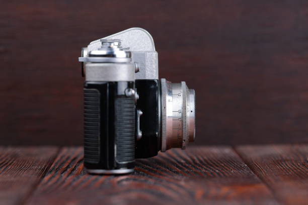 istock The old 35 mm SLR camera on a wooden background. 806785226