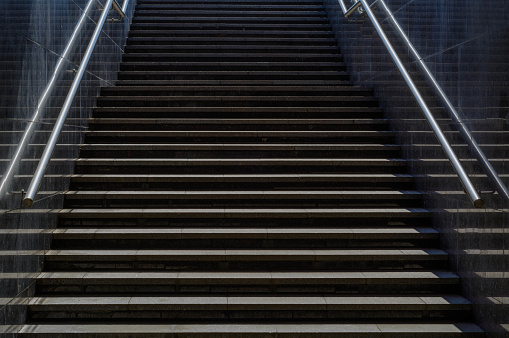 Entrance-exit to the underground passage with steps, metal railings and marble walls