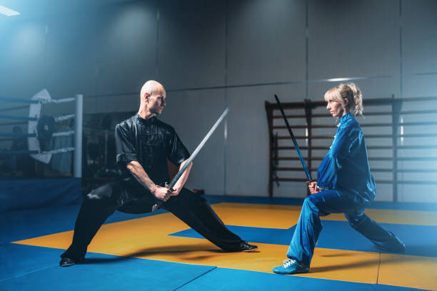 istock Wushu fighters, man and woman with swords 806797206
