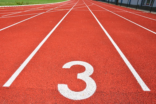 Running track with number 3. Colorful background for sport.