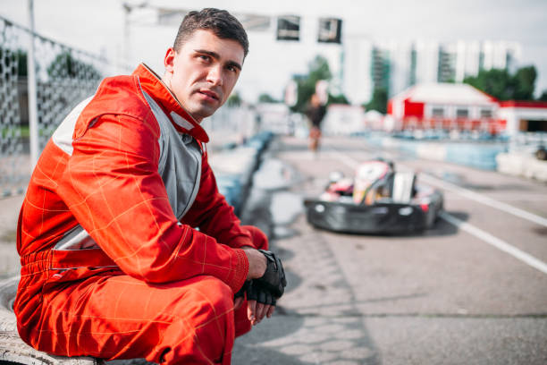 istock Karting racer sits on a tire, kart on background 806819894