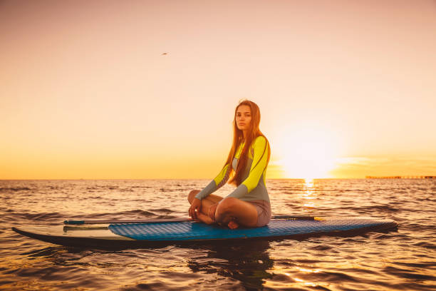 istock Stand up paddle boarding on a quiet sea with warm summer sunset colors 806831600