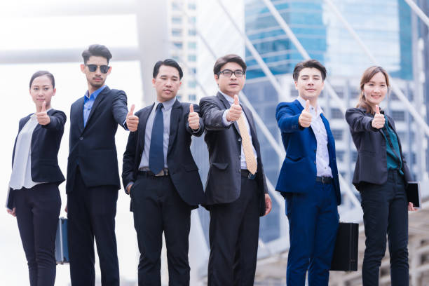 istock Successful business people with thumbs up and smiling 806832476