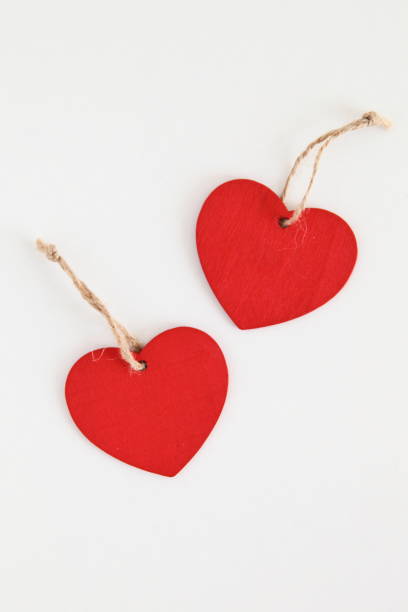 istock Red wooden heart shaped tag with rope isolated on white 806835508