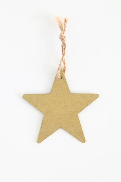 istock Gold wooden star shaped tag with rope isolated on white 806835652