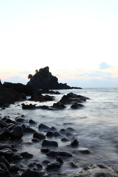 istock Sunrise and morning light on pacific ocean beach with rocks and water 806844464