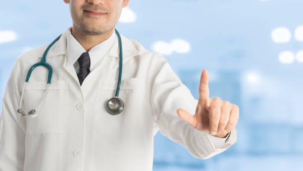 istock Male doctor pointing finger at copy space. 806846980