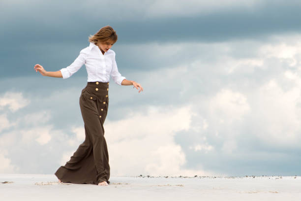 istock The tender girl steps cautiously through the desert 806864490
