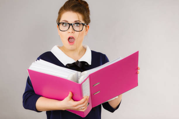 istock Shocked business woman looking at documents 806877088