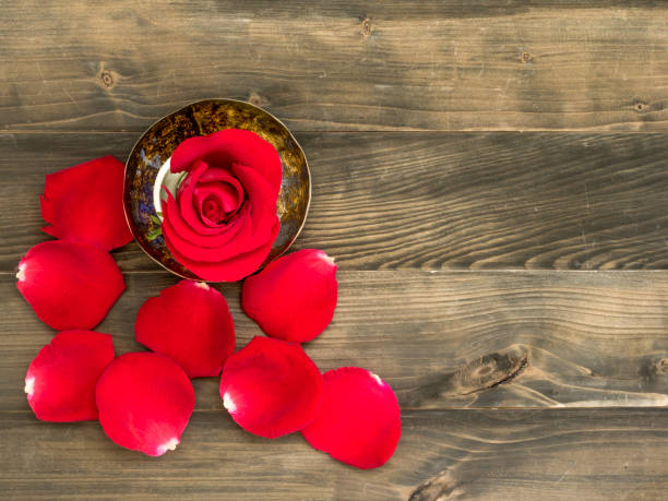 istock Rose and wooden background 806879400
