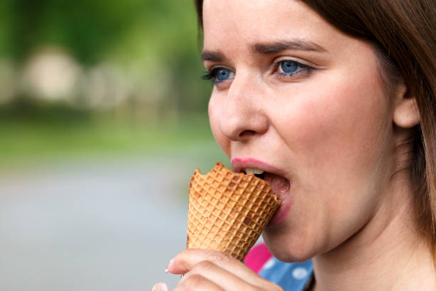 istock Nice girl walking in a public park and eating ice cream 806880596