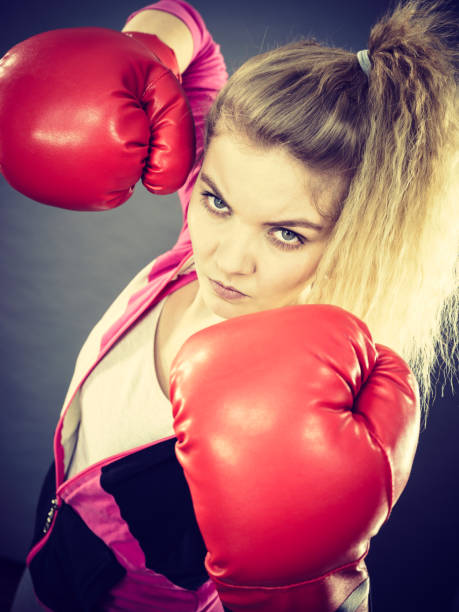 istock Angry woman wearing boxing gloves 806894998