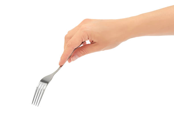 Female hands hold a fork. Isolated on white background stock photo